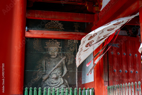 Nio Guardian Statue at Nandaimon Gate with Protective Mesh and Waving Banner, in Nara, Japan