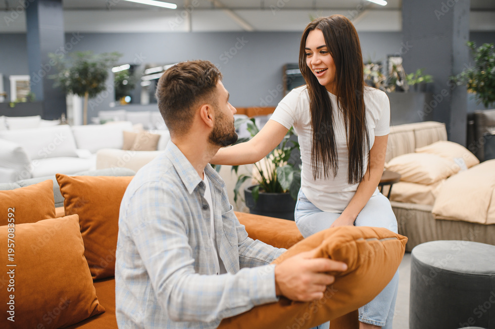 Obraz premium Young couple choosing new sofa for home