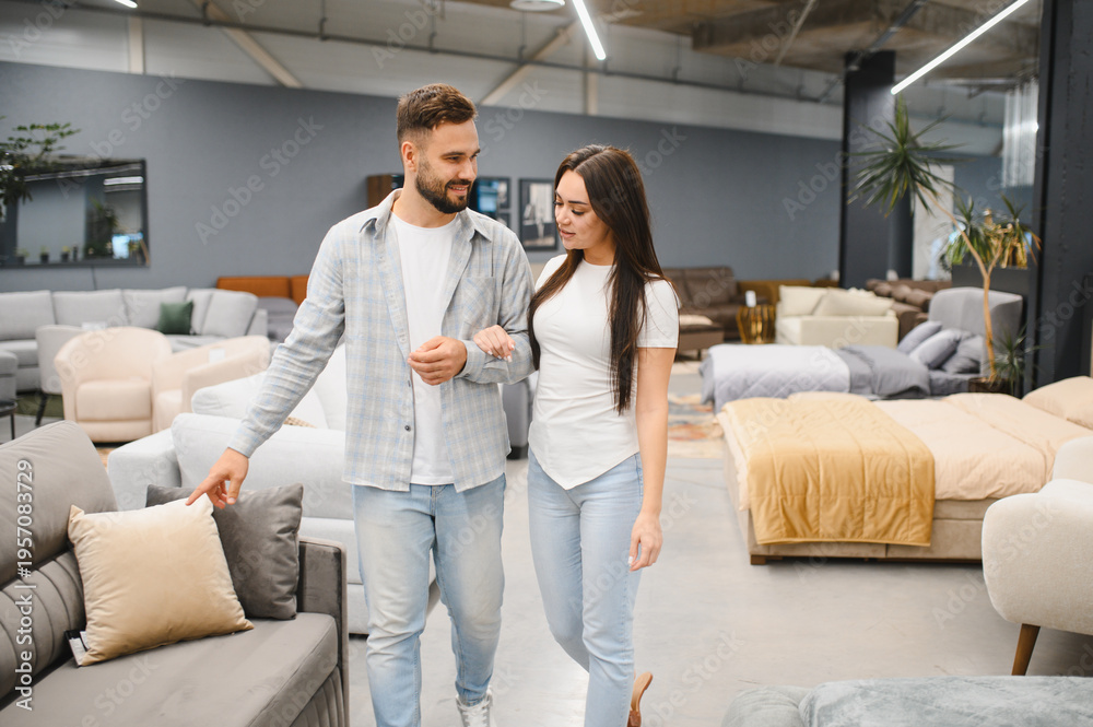 Fototapeta premium Young couple choosing furniture in store for home