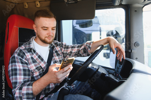 Konstfotografi Truck driver using smartphone in vehicle