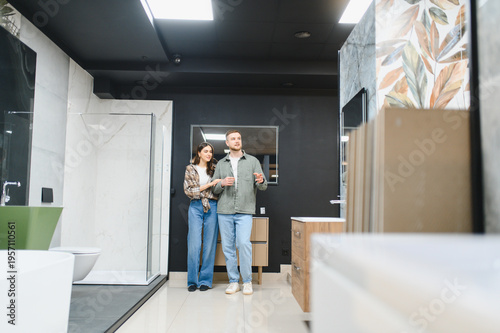 Photos Young couple choosing bathroom tiles and fixtures for home renovation