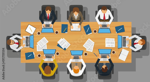 Overhead view of a business meeting with multiple people around a conference table.