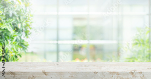 Selective focus.Long banner background with wood table top,counter top with beautiful of blur big glass wall house