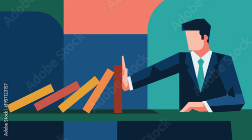 Businessman preventing falling dominoes on desk in office environment