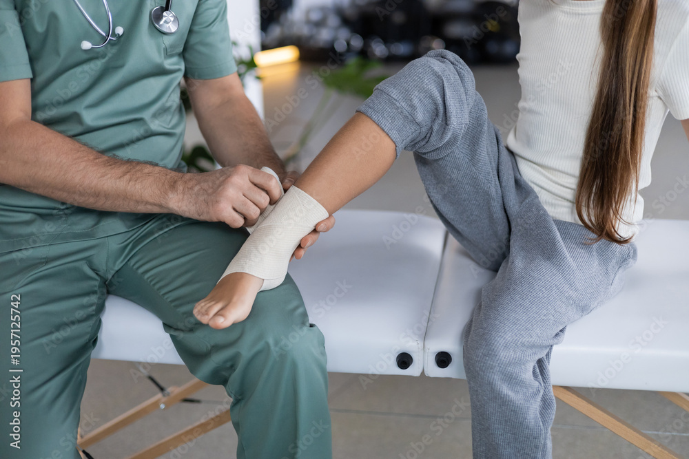 Αυτοκόλλητο Specialist applying compression bandage to girl lower leg