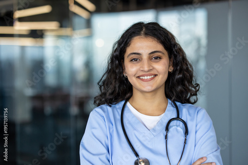 Cuadro en lienzo Smiling indian nurse wearing scrubs holding stethoscope