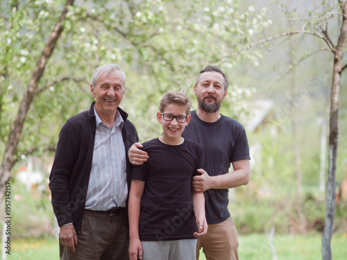 Canvastavla Three generations together: grandfather, father and smiling grandson in a spring