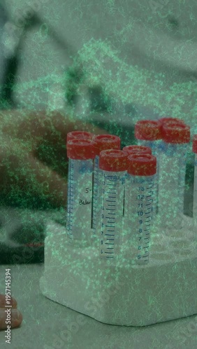 Vertical video: Arm entering lower left, grasping and lifting tube for testing with green overlay