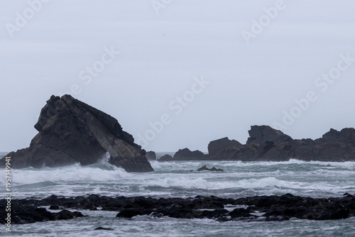 Stormy ocean waves crashing on rocky coastline Australia