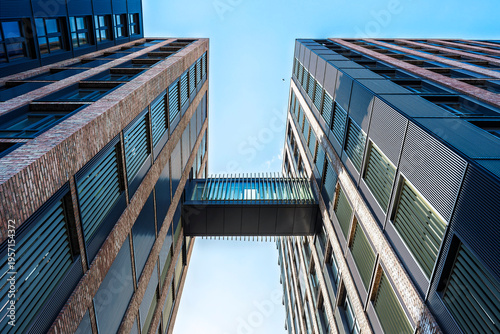 Photos Modern brick buildings with glass skybridge in Dublin Ireland, contemporary urban architecture and clear blue sky