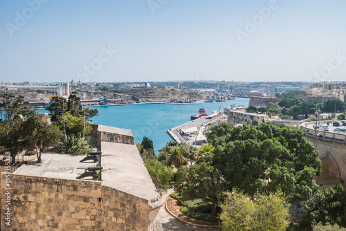 St. James Counterguard Garden with cannons, Floriana marine and Kordin terminals in the background, Valletta MALTA
