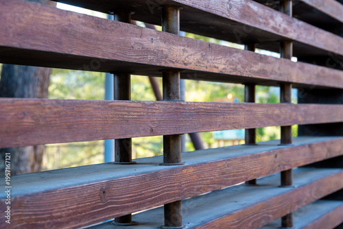 Angled view of wooden slat railing with posts