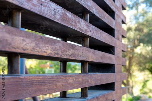 Wooden slat railing detail with metal posts