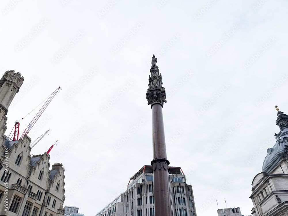 Naklejka premium Historic Crimea and Indian Mutiny memorial monument column rising above surrounding architecture in central London, UK skyline. Westminster Scholars War Memorial.