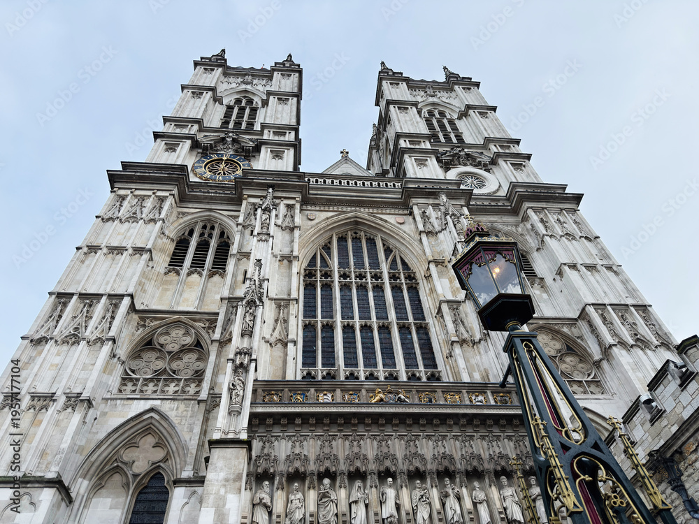 Fototapeta premium Westminster Abbey façade and twin towers with historic lantern in London, UK, dramatic low-angle view