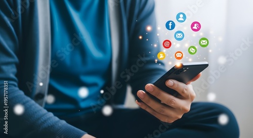 Man using smartphone with social media icons floating above technology background