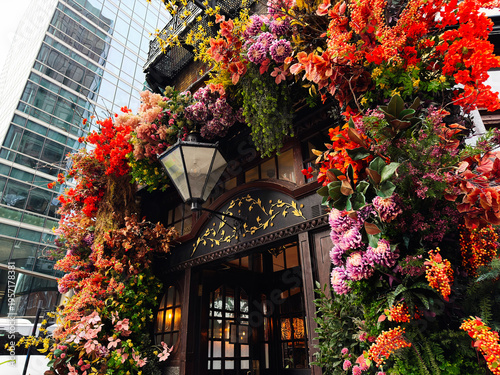 Photography Vibrant floral pub entrance with overflowing flower display in London, UK city c