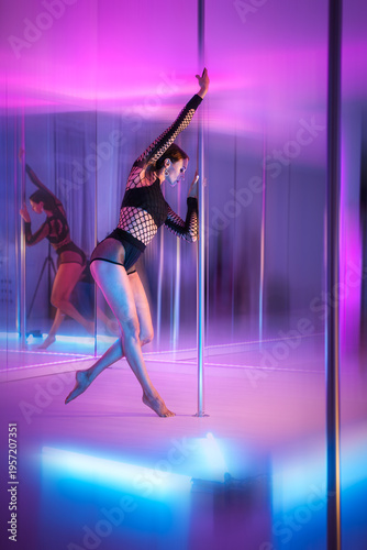 Female Pole Dancer In Studio With Pink And Blue Neon Lighting