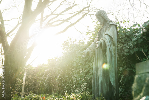 Konstfotografi Statue von Jesus auf einem Friedhof im Gegenlicht, Konzept Glaube und Tod