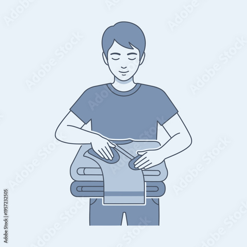 Person folding clothes on a stack of laundry.