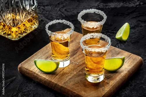 Wallpaper Mural Tequila shots with salted rims and lime slices, with a decanter, on black Torontodigital.ca