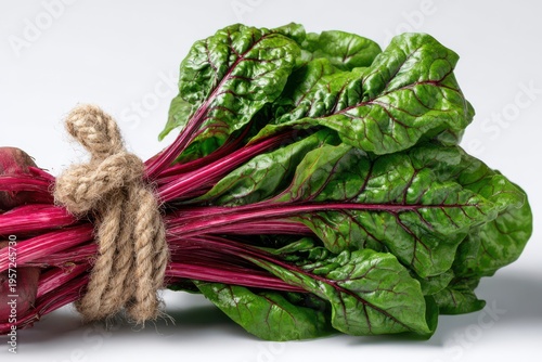 Beet greens tied with rope on white