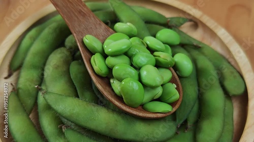 Edamame soy beans in wooden spoon.