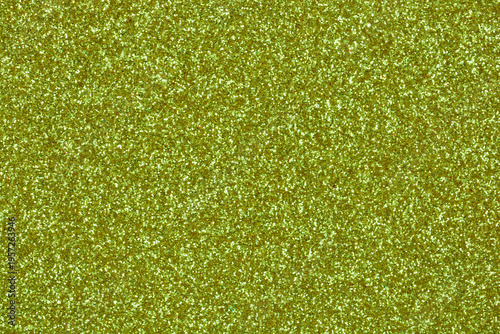 A dense shimmering light green glitter background with a fine sparkling texture and brilliant metallic reflections