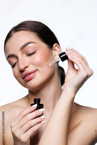 Εκτύπωση καμβά Close-up young female applying facial serum, using anti-aging treatment product,