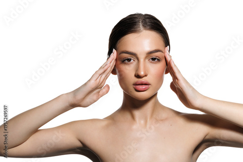 Woman gently touching her skin after beauty treatments. Beautiful model with bare shoulders.
