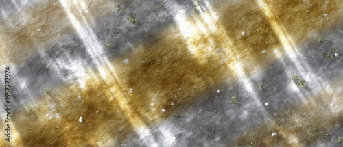 Sunlight reflects on sand forming ripples and shapes on a beach. The scene shows a light atmosphere with warm colors