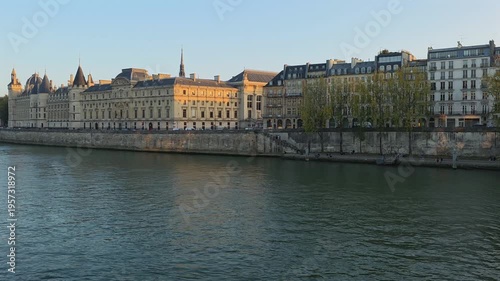 Seine River Cruise Boat Passing Historic Buildings at Sunset in Paris France