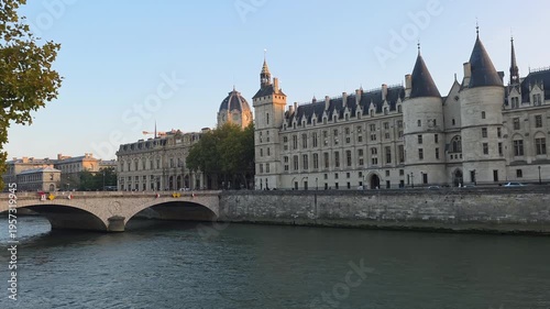 Seine River Cruise Boat Passing Historic Buildings at Sunset in Paris France