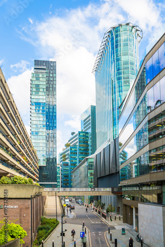 Office skyscrapers and Barbican city development of 1960 in the City of London. Walking people
