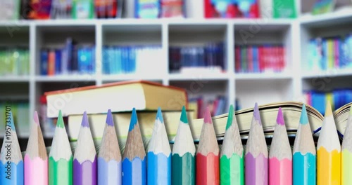 Animation of pencils and schoolbooks over library background