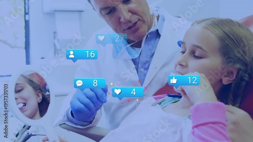 The dentist is helping the young patient brush their teeth in the dental clinic