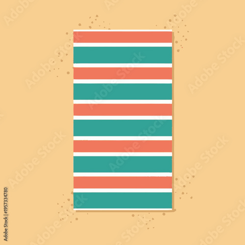 A vibrant beach towel with alternating coral and teal stripes lies on a sandy surface with scattered grains.