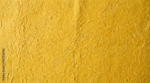 A close-up shot of textured, yellow paper. The paper has a rough, wrinkled surface with visible fibers and slight imperfections.