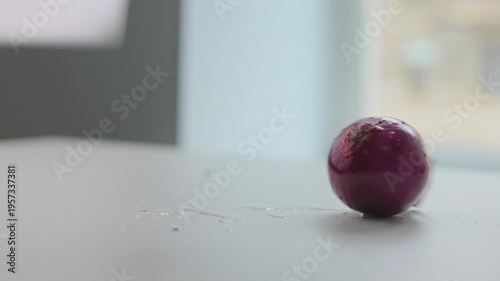 Fresh red onion rotating on table, cooking ingredient close up