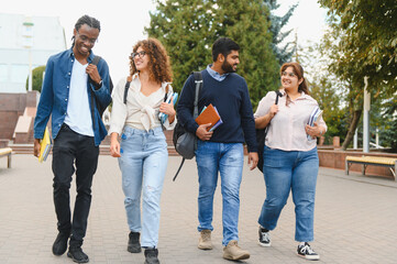 Diverse students walking on university campus together