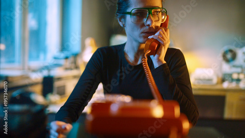 Cuadro en lienzo Woman using a old retro landline phone to answer an emergency call