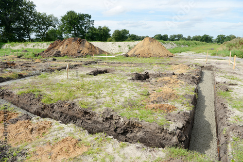 Construction site with freshly poured concrete foundation