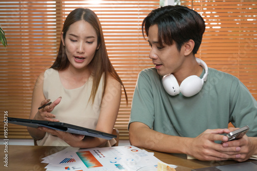 A young Asian couple spend time together at home