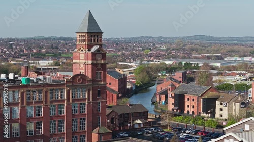 WIGAN, GREATER MANCHESTER, ENGLAND - MARCH 18, 2026: Wigan Pier and industrial mill alongside the Leeds and Liverpool Canal
