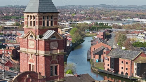 WIGAN, GREATER MANCHESTER, ENGLAND - MARCH 18, 2026: Historic mill and Leeds and Liverpool Canal at Wigan Pier, an iconic industrial heritage waterfront