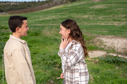 Boy and girl bonding outdoors having conversation