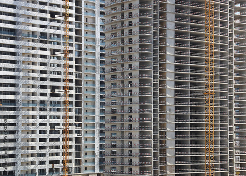 Konstfotografi Construction cranes and unfinished building as background backdrop