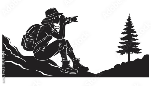 A photographer in silhouette taking a picture on a mountain