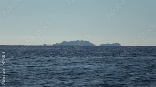 Kas, Turkey - 14 of February 2026: 4K Zoom out Fata Morgana superior mirage of islands over the sea horizon
