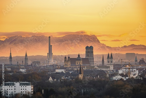 View over Munich with Church of Our Lady, Theatine Church, Ludwigskirche, behind Zugspitze at sunset, Munich, Bavaria, Germany